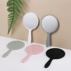Miroir maquillage portable poche rond verre plastique mat poignée ergonomique léger compact voyage retouche minimaliste coloré rose noir blanc