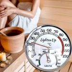 thermohygromètre sauna mural analogique cadran rond chromé verre fond blanc aiguilles rouges dorées lecture rapide contrôle température humidité